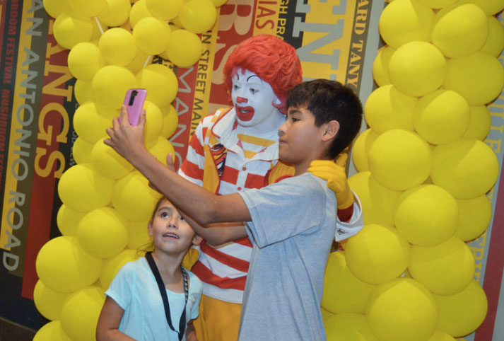 Kids take a selfie with Ronald McDonald in Madisonville, Texas